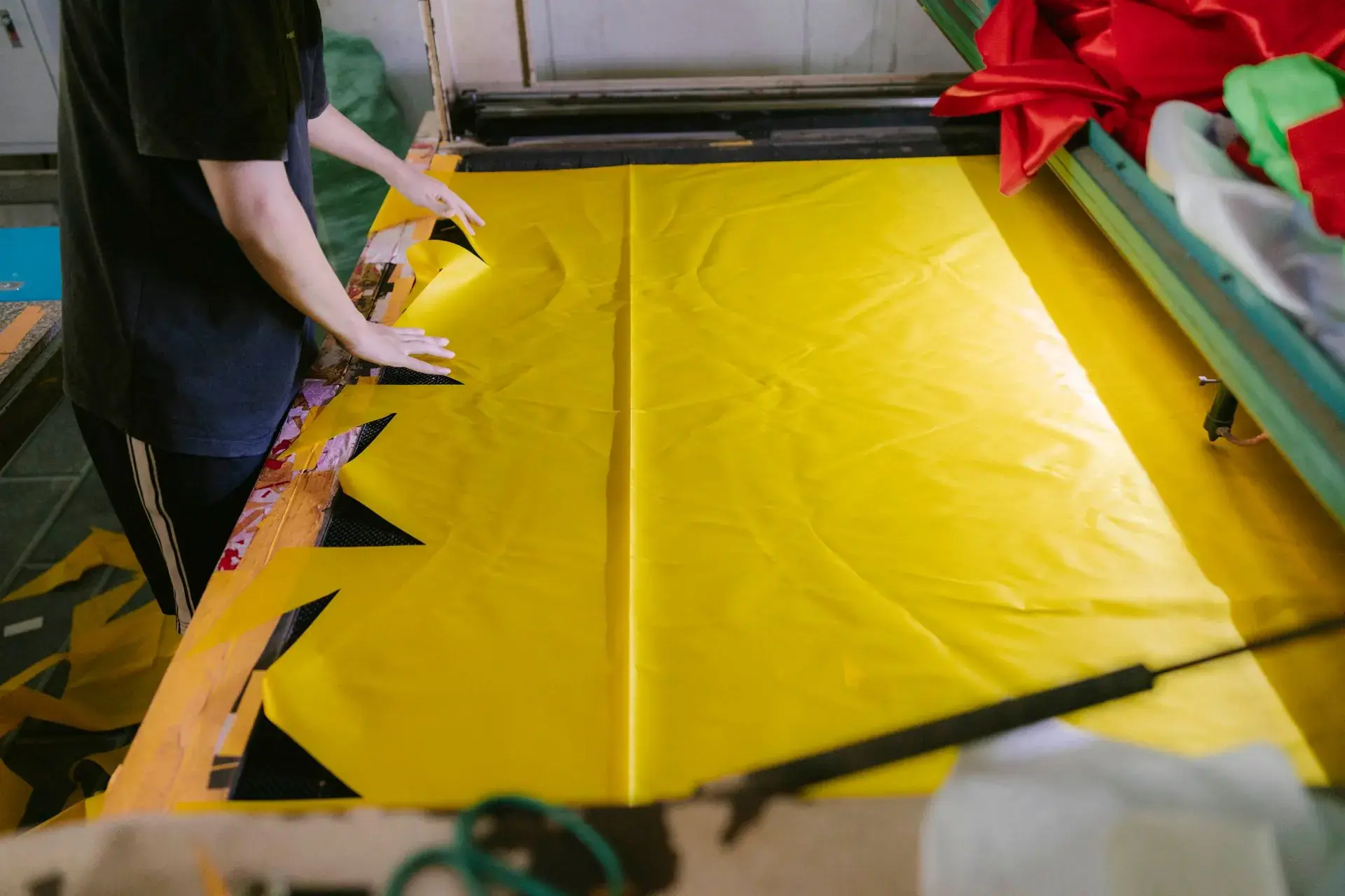 Fabric panel being cut to pattern with shears — stock illustration standing in for Bundled panels numbered by size at Lahajam, Lahore