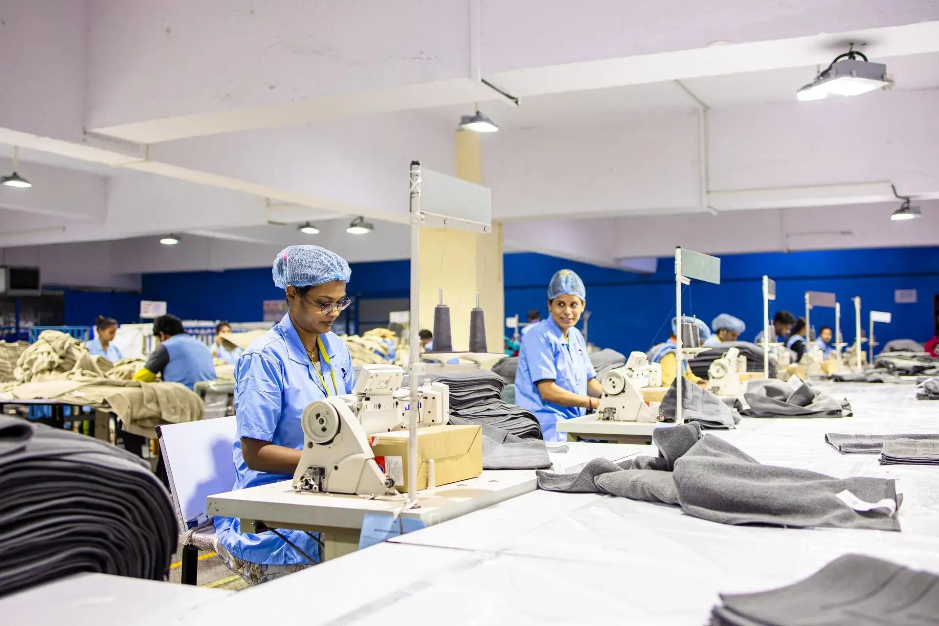 Stacks of folded garments ready for packing — stock illustration standing in for Labelling and polybagging at Lahajam, Lahore