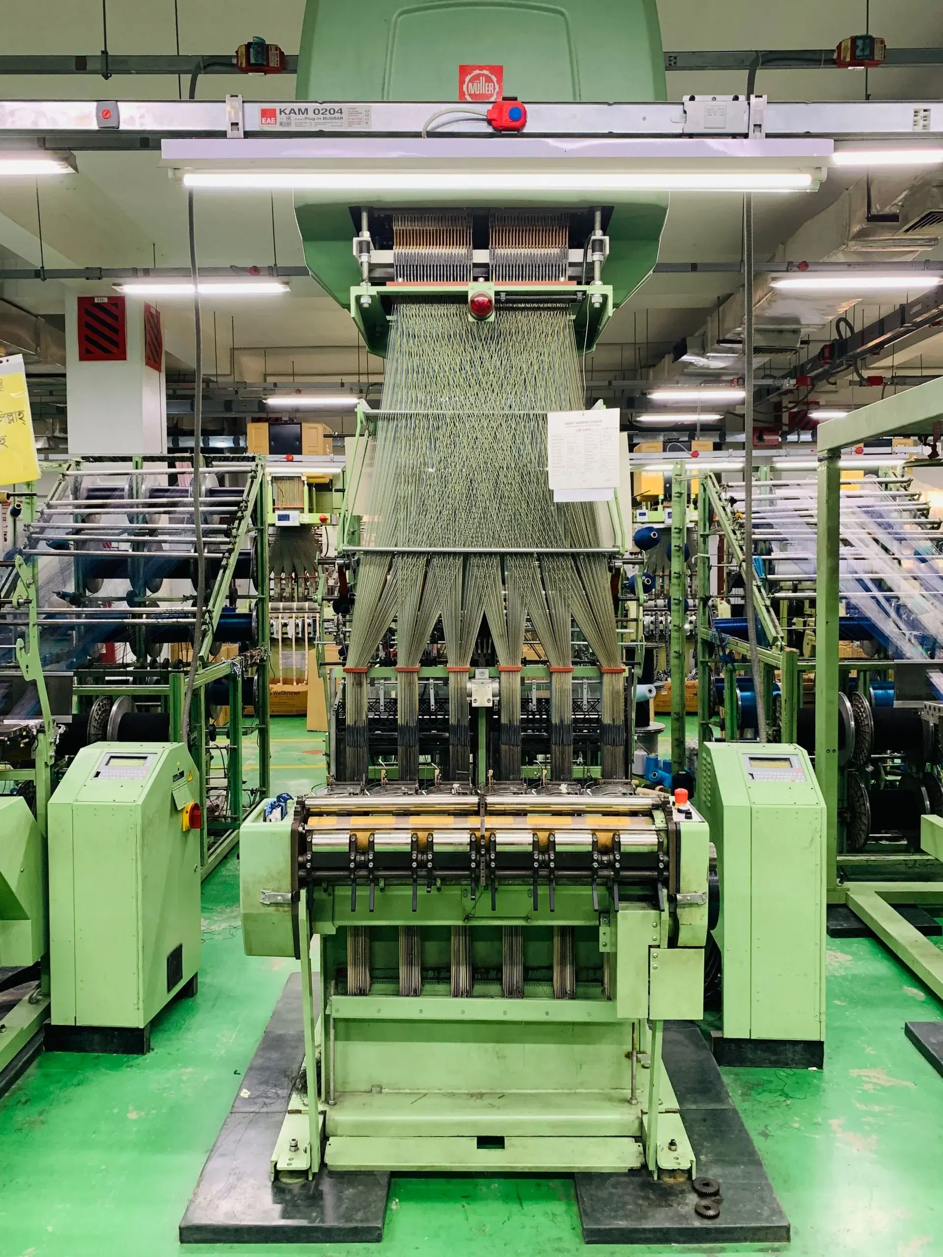 Industrial knitting machine producing knit fabric
