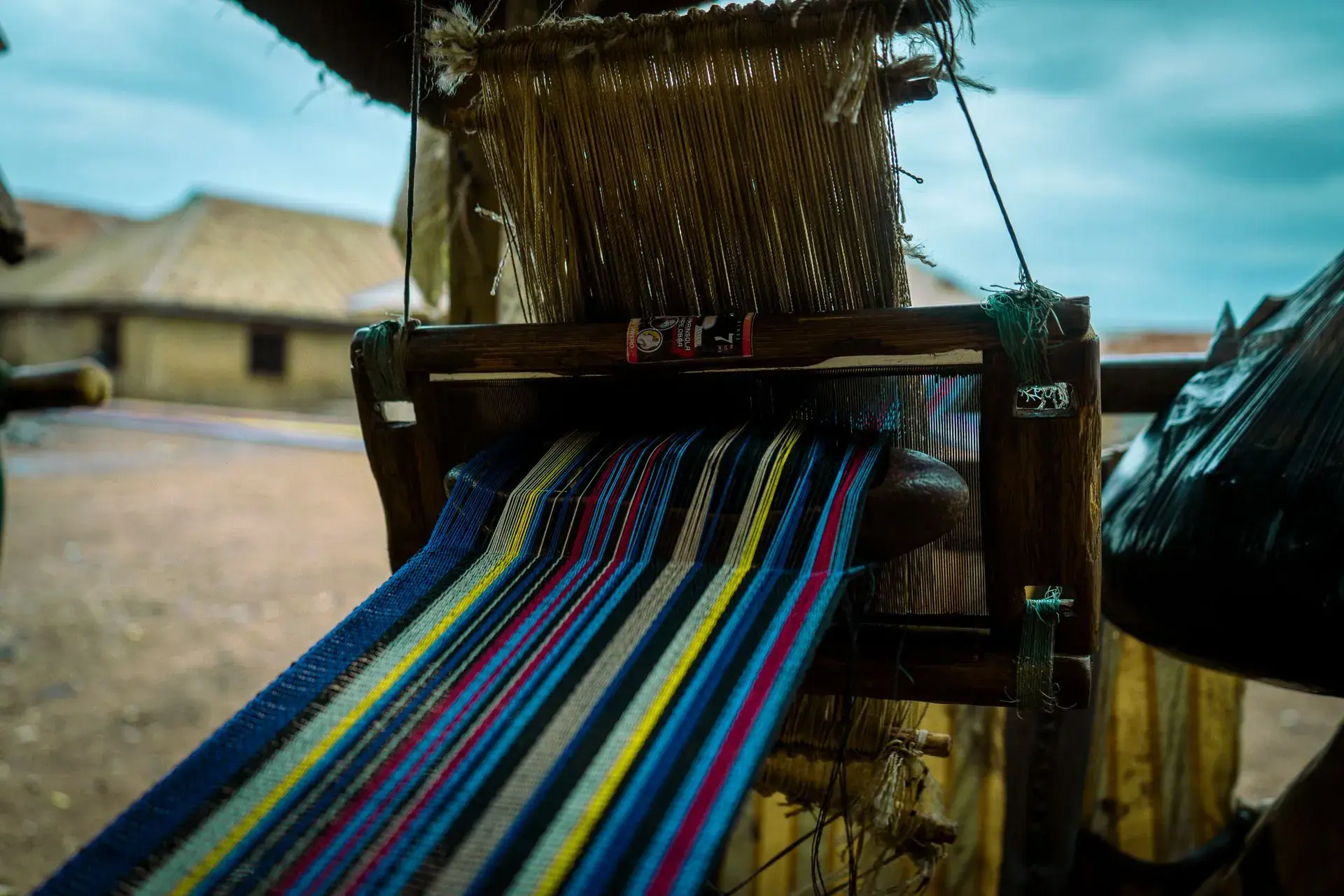 Traditional loom weaving coloured woven fabric
