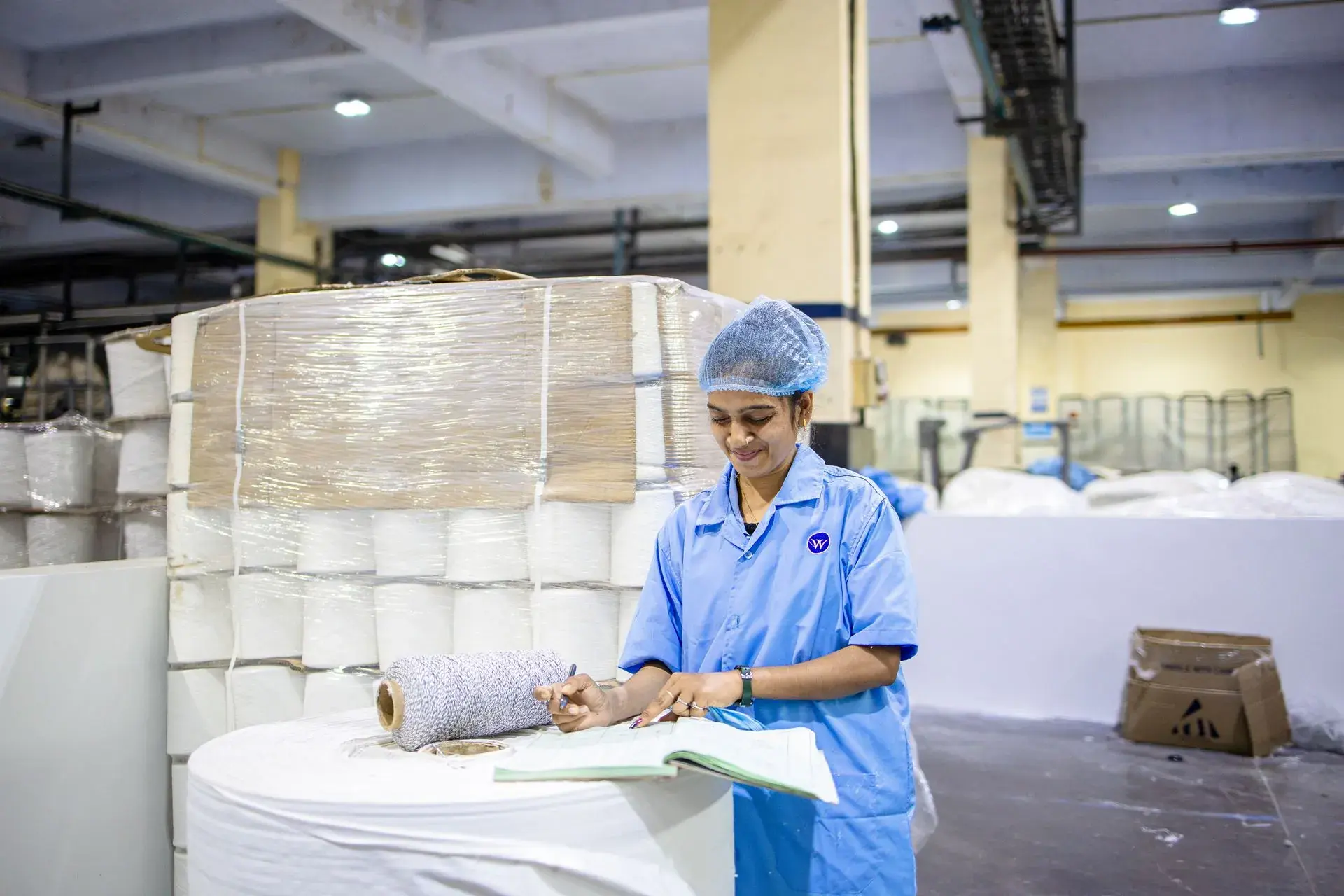 Finished garments being packed into cartons for dispatch — stock illustration standing in for Cartons packed and marked for dispatch at Lahajam, Lahore