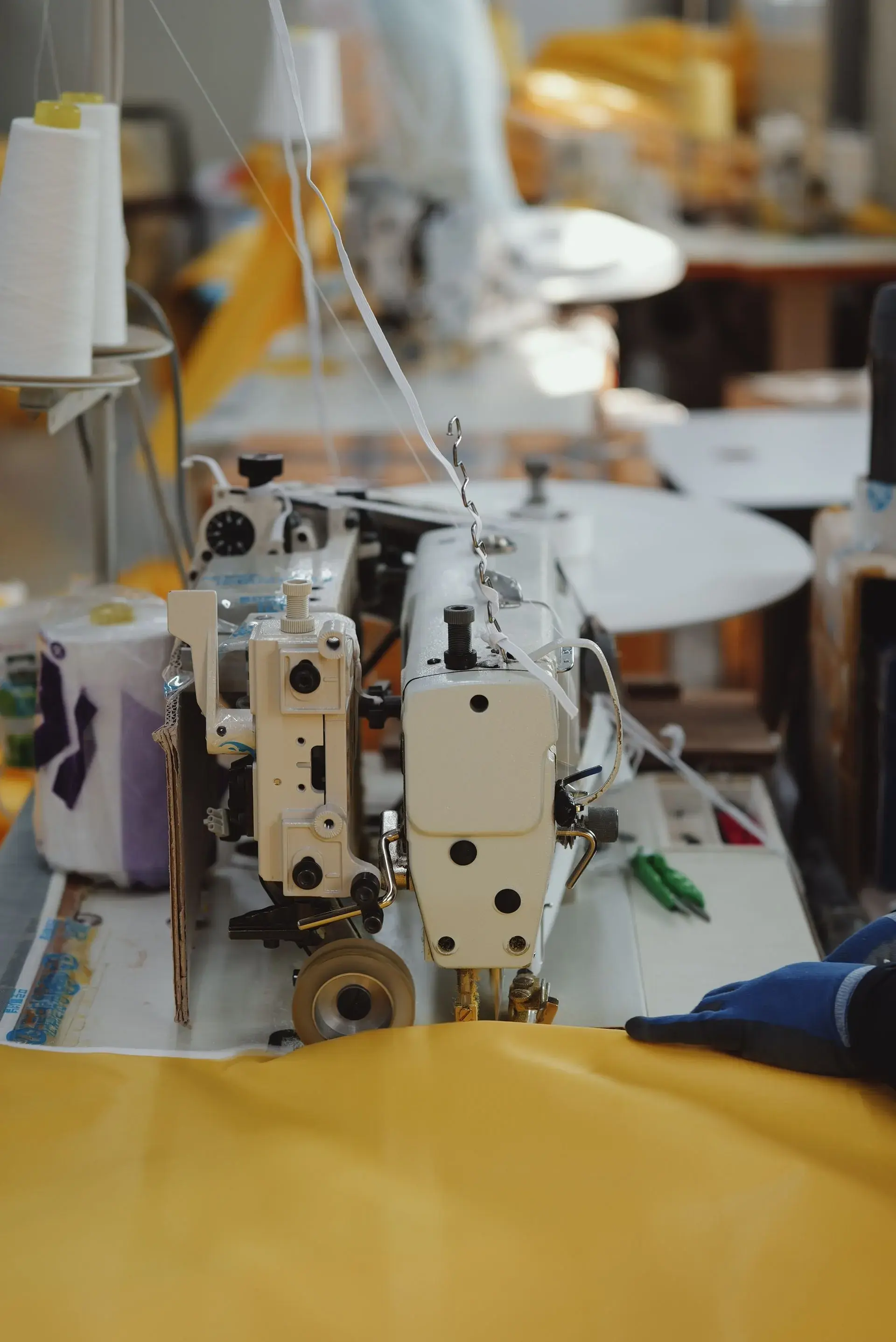 Industrial single-needle lockstitch sewing machine on the line — stock illustration standing in for Woven line — single-needle assembly of shirts at Lahajam, Lahore